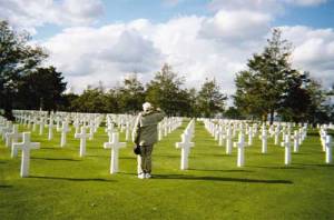 A moment of silent tribute at the Omaha Beach Cemetery in Normandy, France, photographed by Benjamin Finch, 6-time traveler from State College, Pennsylvania. The memorial here commemorates the site of the first American cemetery on European soil in World War II.